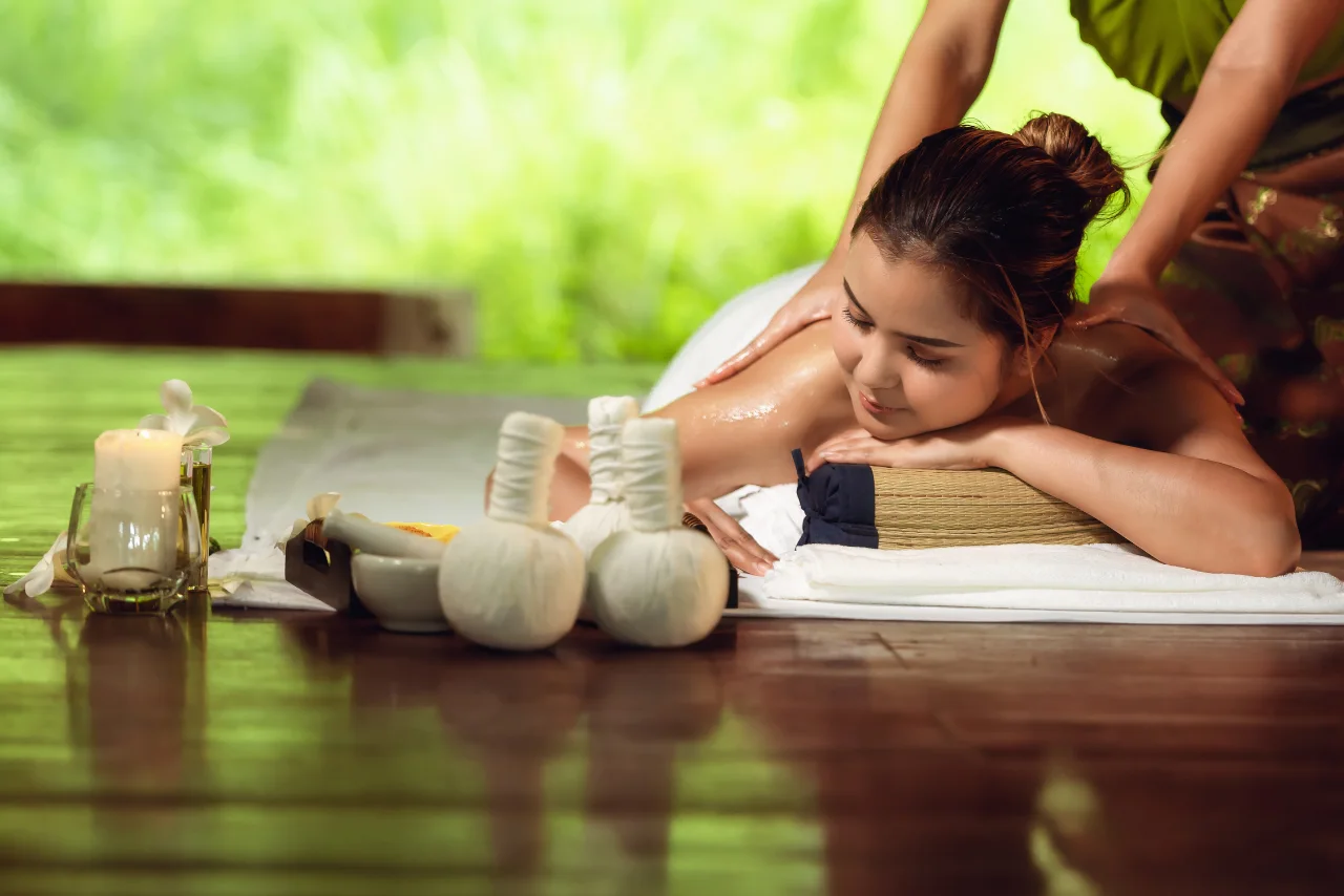 rofessional therapist performing herbal potli massage at Lexus International Spa Bangalore