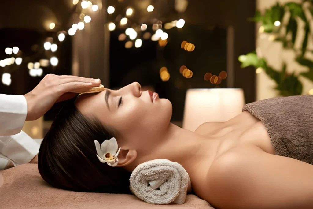 Woman enjoying a calming facial massage with soft candlelight ambiance at Nexus International Spa in Banashankari, Bangalore